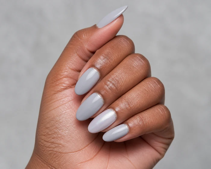 Dove gray simple winter nails with pearl sheen on a Black womans hand