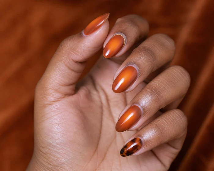 Burnt orange aura nails with gold halo and tortoiseshell accent
