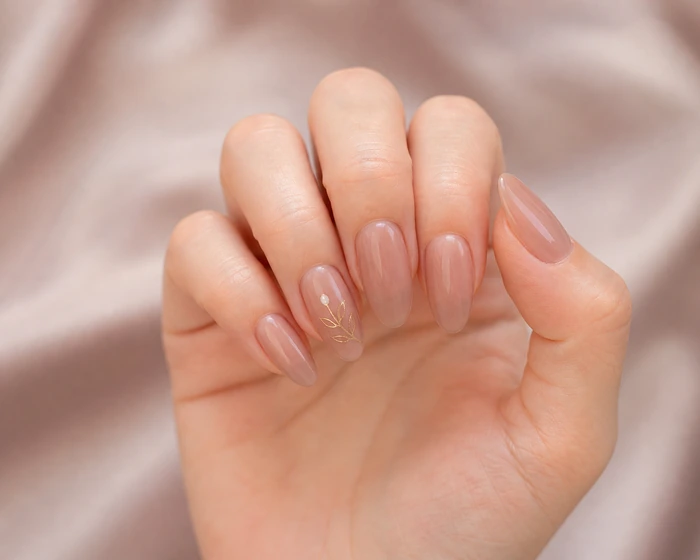 Taupe nude almond nails with soft leaf detail for November