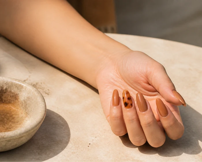 Caramel acrylic almond nails with a tortoiseshell accent