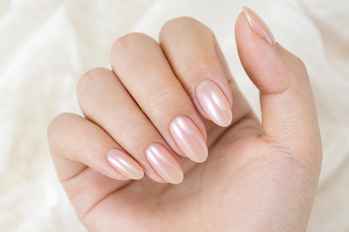 Opalescent pearl nude pretty fall nails in a hand-only close-up