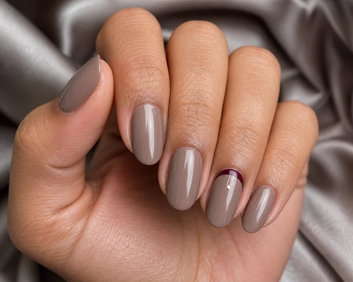 Taupe oval nails with burgundy half-moon detail