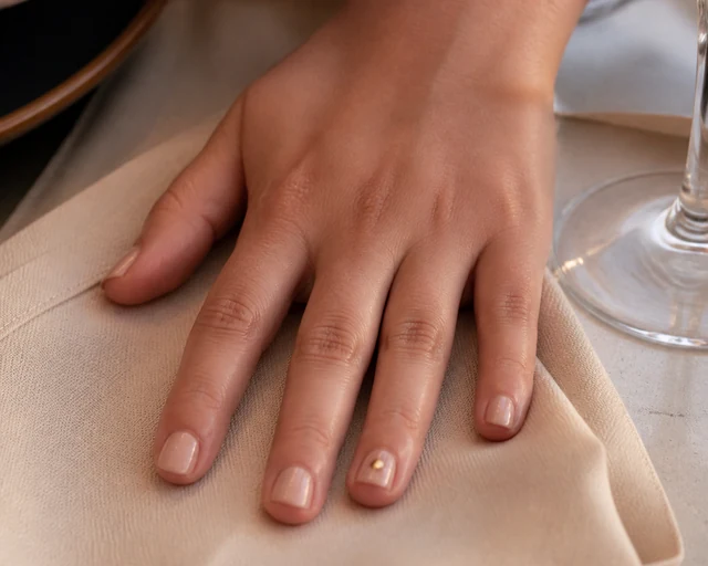 Short Square With Gold short autumn nail design on a woman’s hand.