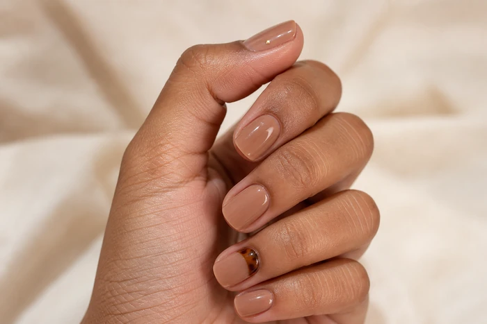 Caramel nails with a tortoiseshell crescent accent