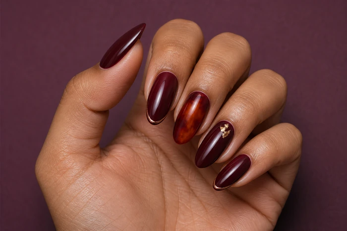 Merlot acrylic nails with amber marble and gold foil