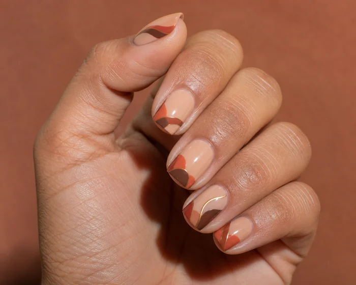Warm nude square nails with terracotta ribbon art