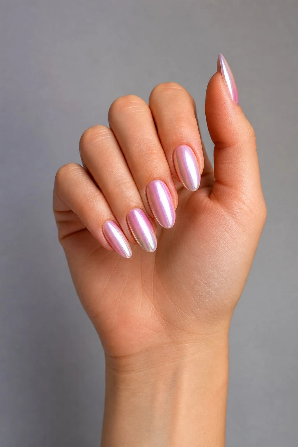 Pink Pearl Chrome Nails in a curled hand pose with thumb clearly separated