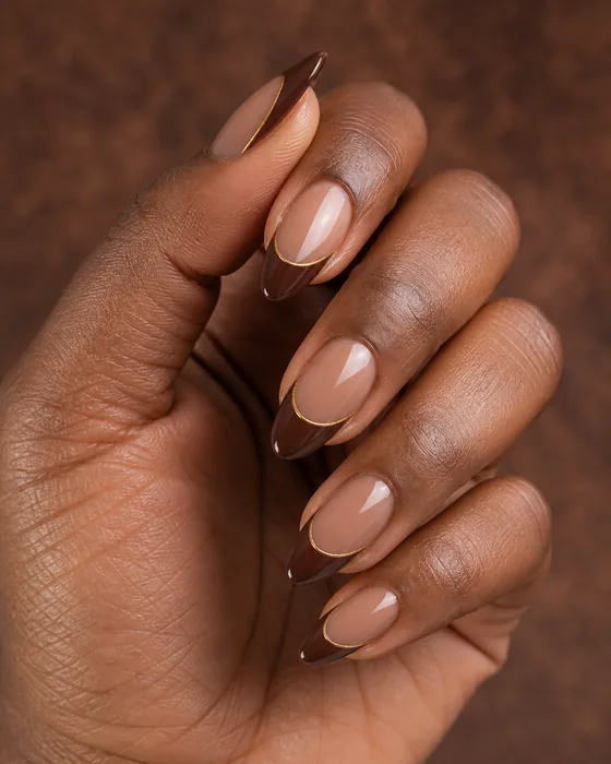 Medium cocoa gel nails with gold-edged French tips