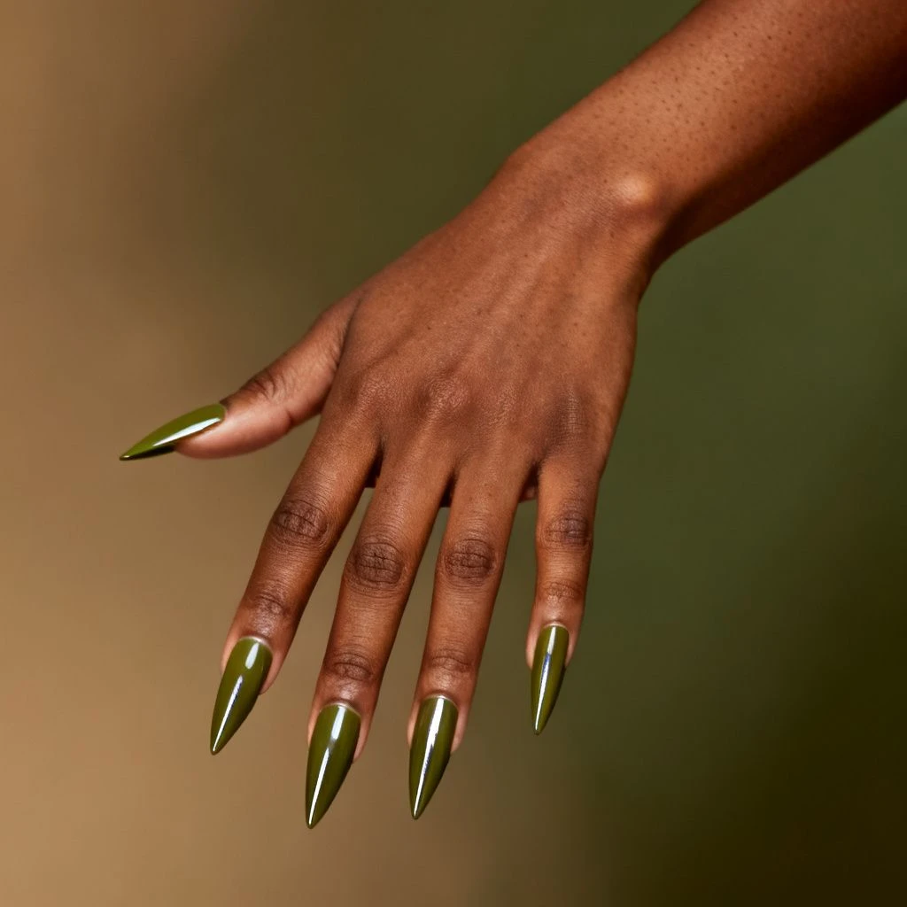 Long olive stiletto acrylic nails with a thin silver line