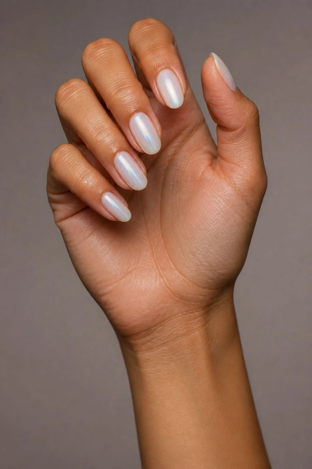 Opalescent Milky Oval Nails in a curled hand pose with thumb clearly separated
