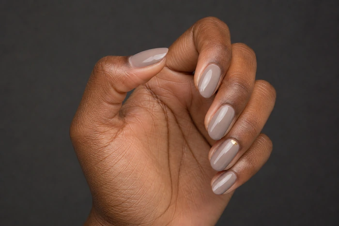 Soft taupe nails with a small gold foil accent