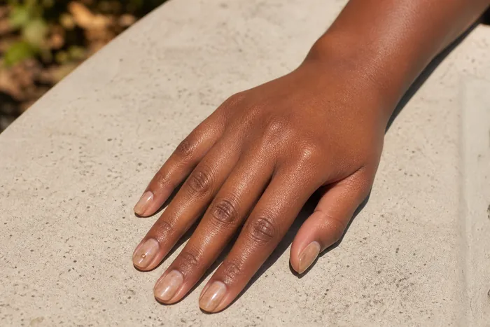 Milky caramel pearl fall nails with a bronze accent