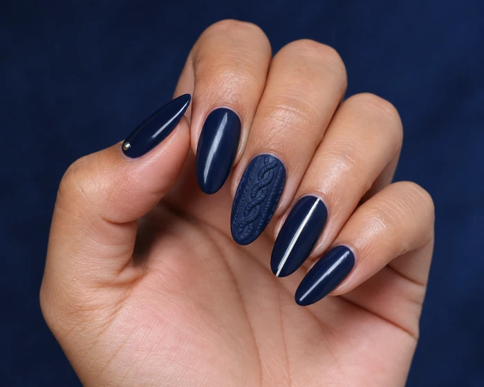 Deep navy sweater nails with pearl line detail on a Latina womans hand