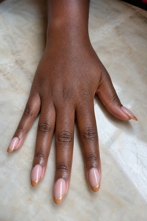 Caramel French oval nails with thin gold line