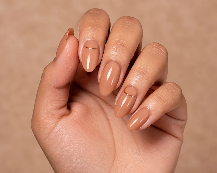 Caramel nude nails with a fine copper line