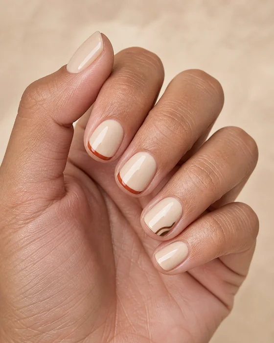 Short cream nails with burnt pumpkin French tips
