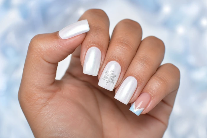 White pearl winter nails with icy blue French and snowflake line