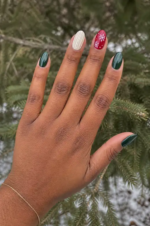 Green and red Christmas sweater nails with snowflake detail outdoors