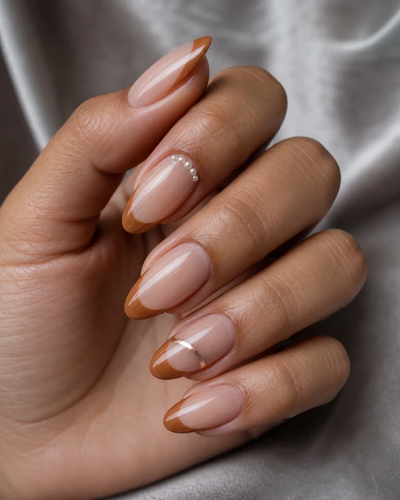 Caramel French almond nails with pearl and metallic details