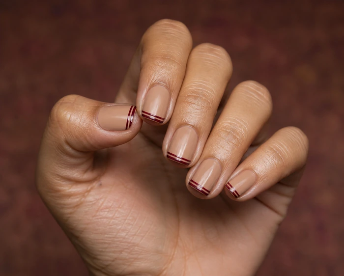Short caramel square nails with burgundy double French