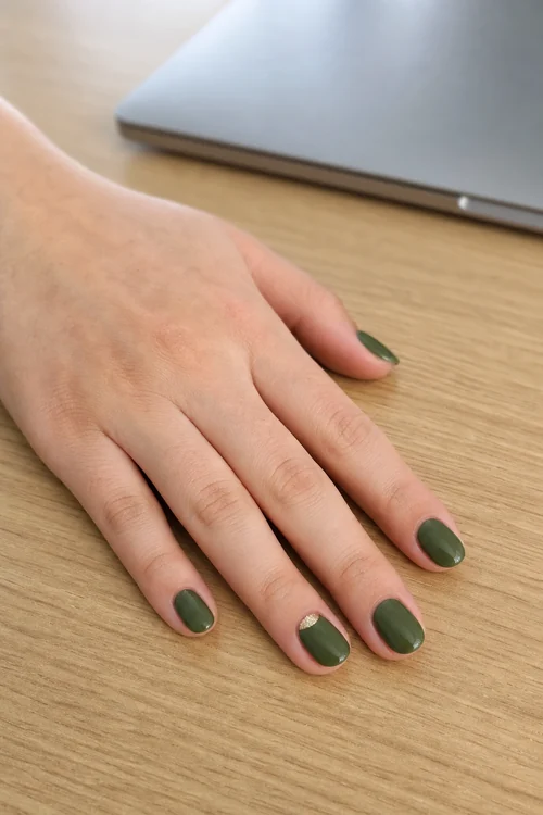 Short olive green oval nails with gold half moon accent