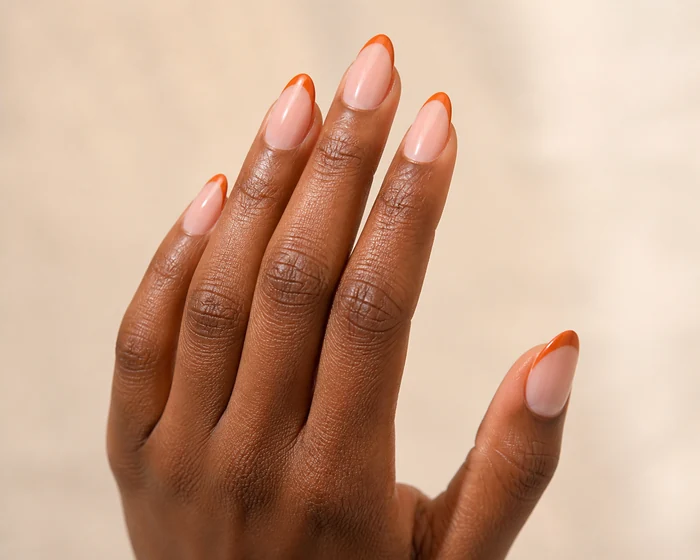 Sheer nude nails with thin rust French tips