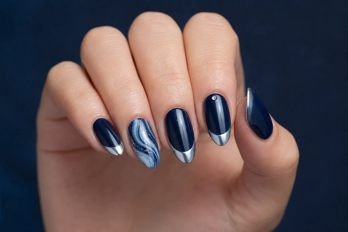 Midnight blue chrome winter nails with icy swirl accent