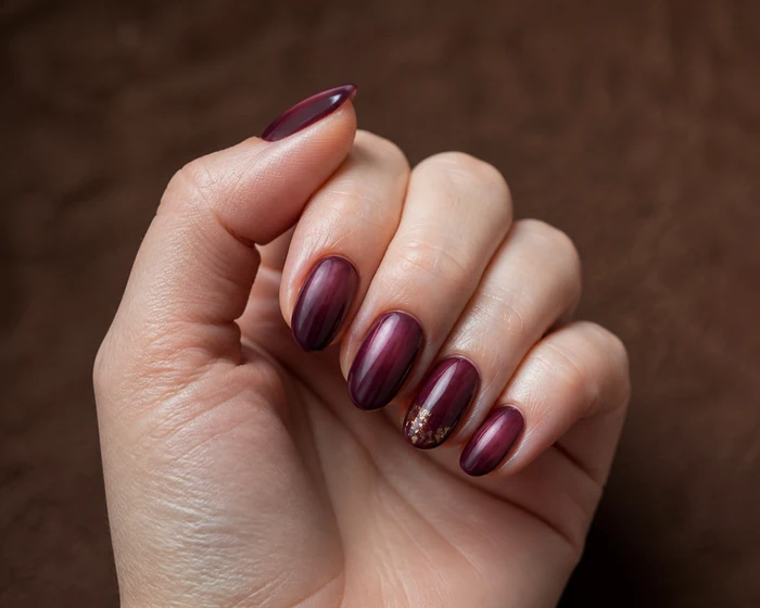 Plum aura nails with subtle copper foil accent art