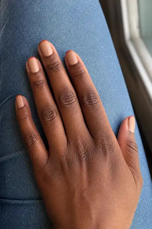 Short nude oval nails with rust French tips