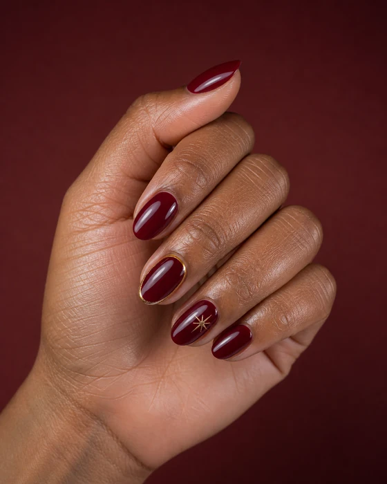 Short cranberry Thanksgiving nails with gold starburst nail art