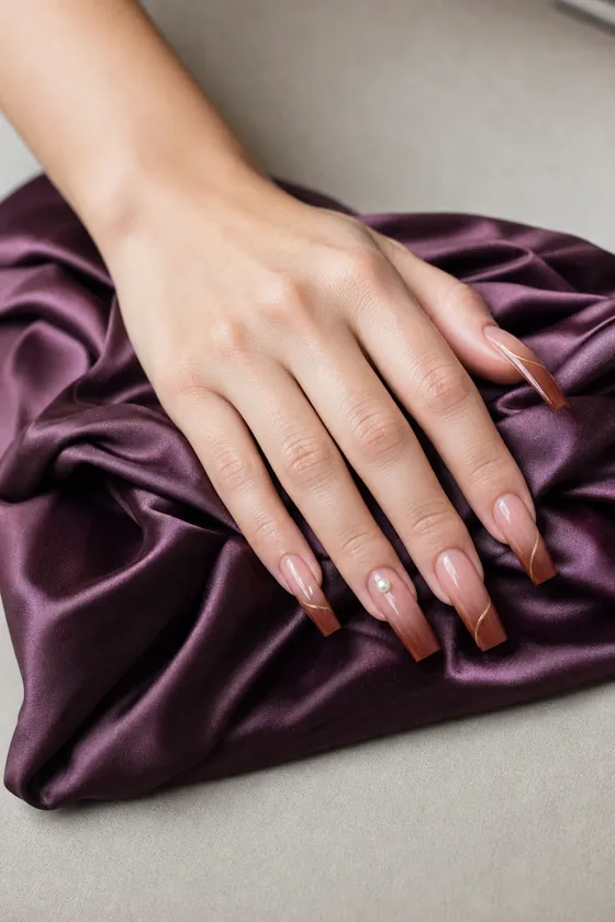 Long copper and burgundy ombre coffin fall nails on plum satin