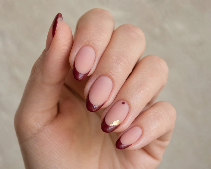 Matte cranberry French Thanksgiving nails with gold foil accent