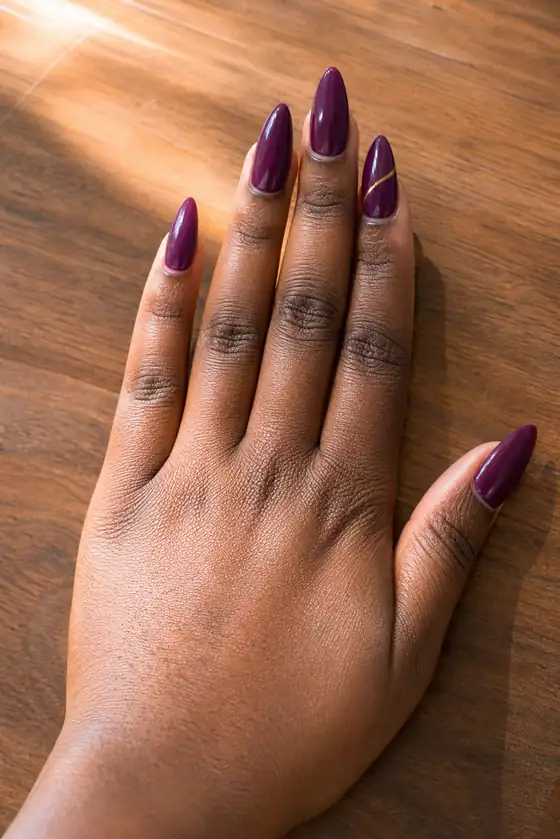 Purple plum gold line art on long fall stiletto nails