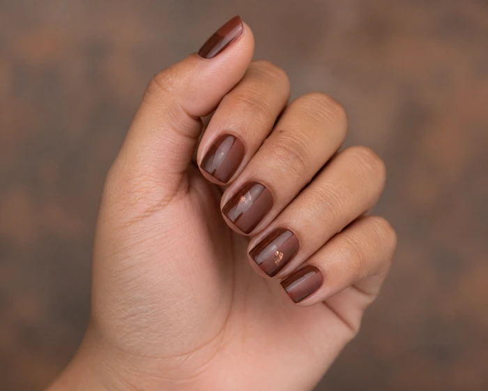 Short warm brown acrylic nails with gloss matte split and foil fleck