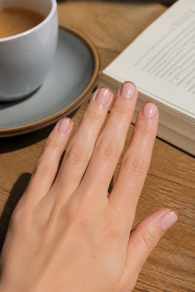 Short natural nails with a warm mocha micro French line.