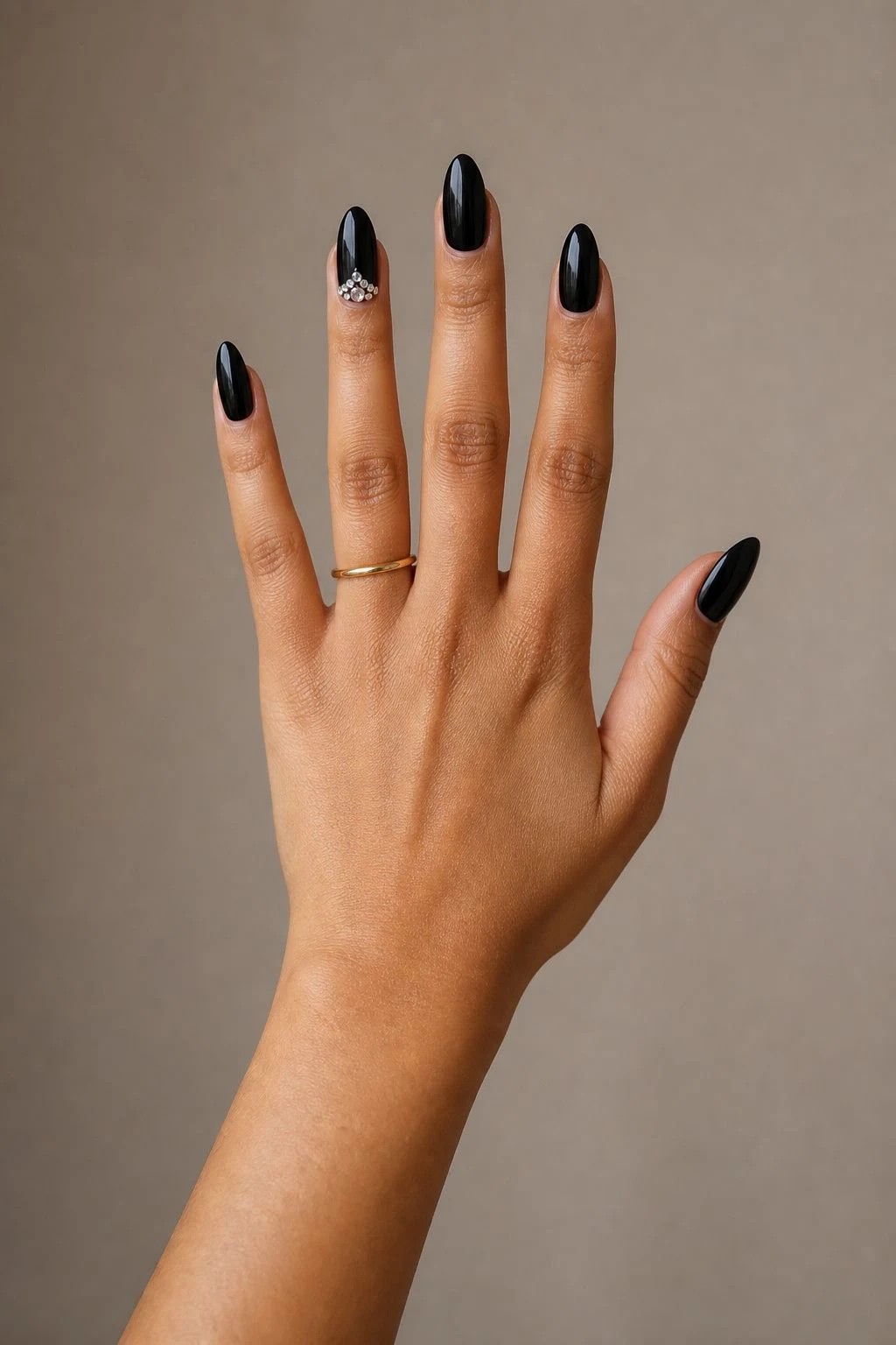 Black With Crystal Accent baddie Christmas nails with a delicate gold ring
