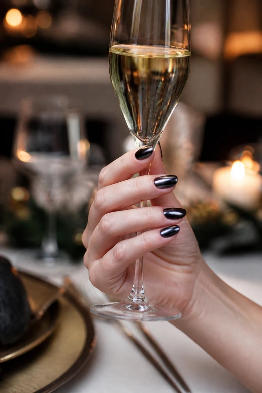 Black chrome oval Christmas nails on a woman’s full hand