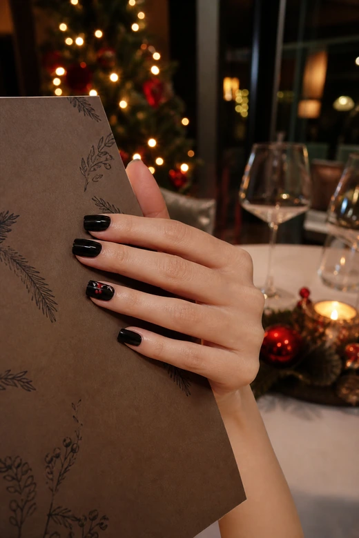 Black nails with a tiny red berry accent