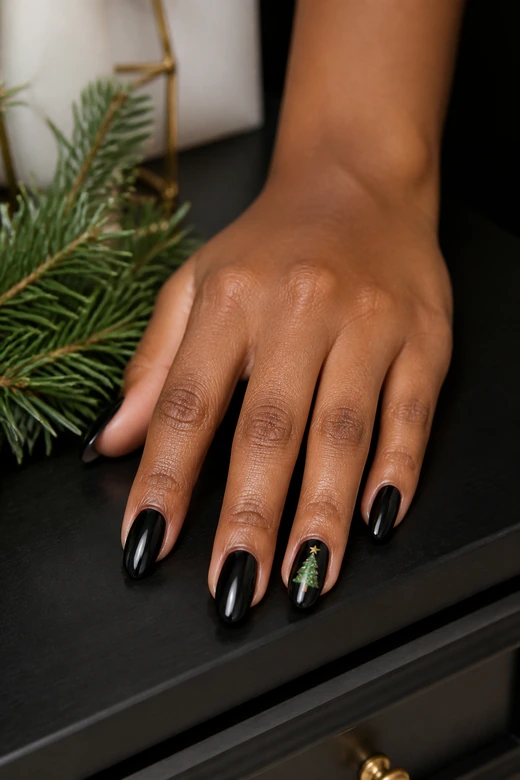 Black nails with a mini green Christmas tree accent