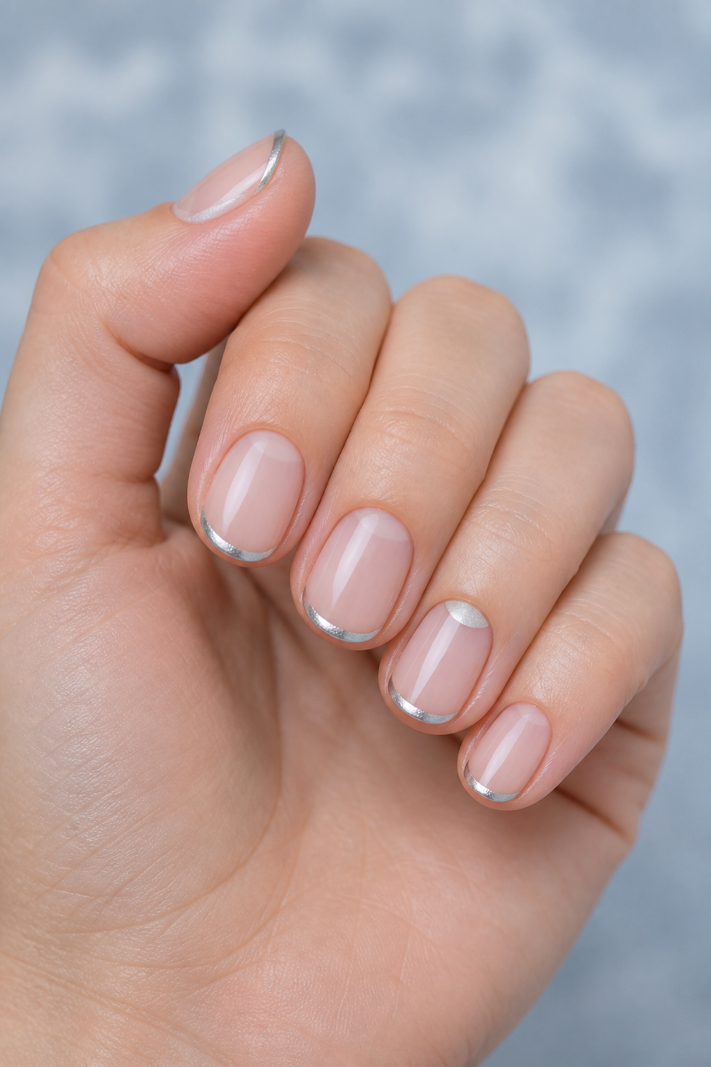 Icy silver chrome micro-French Christmas nails.
