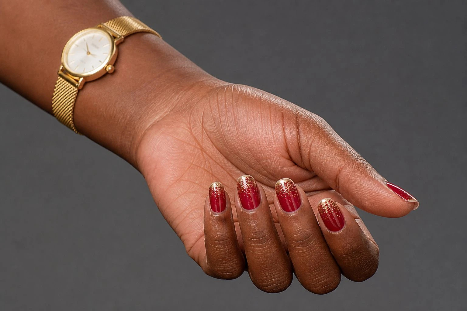Short red Christmas nails with gold glitter tips