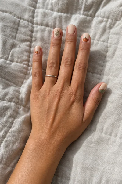 Minimal harvest line art manicure on short square nude nails with satin gloss, relaxed hand pose, medium skin tone