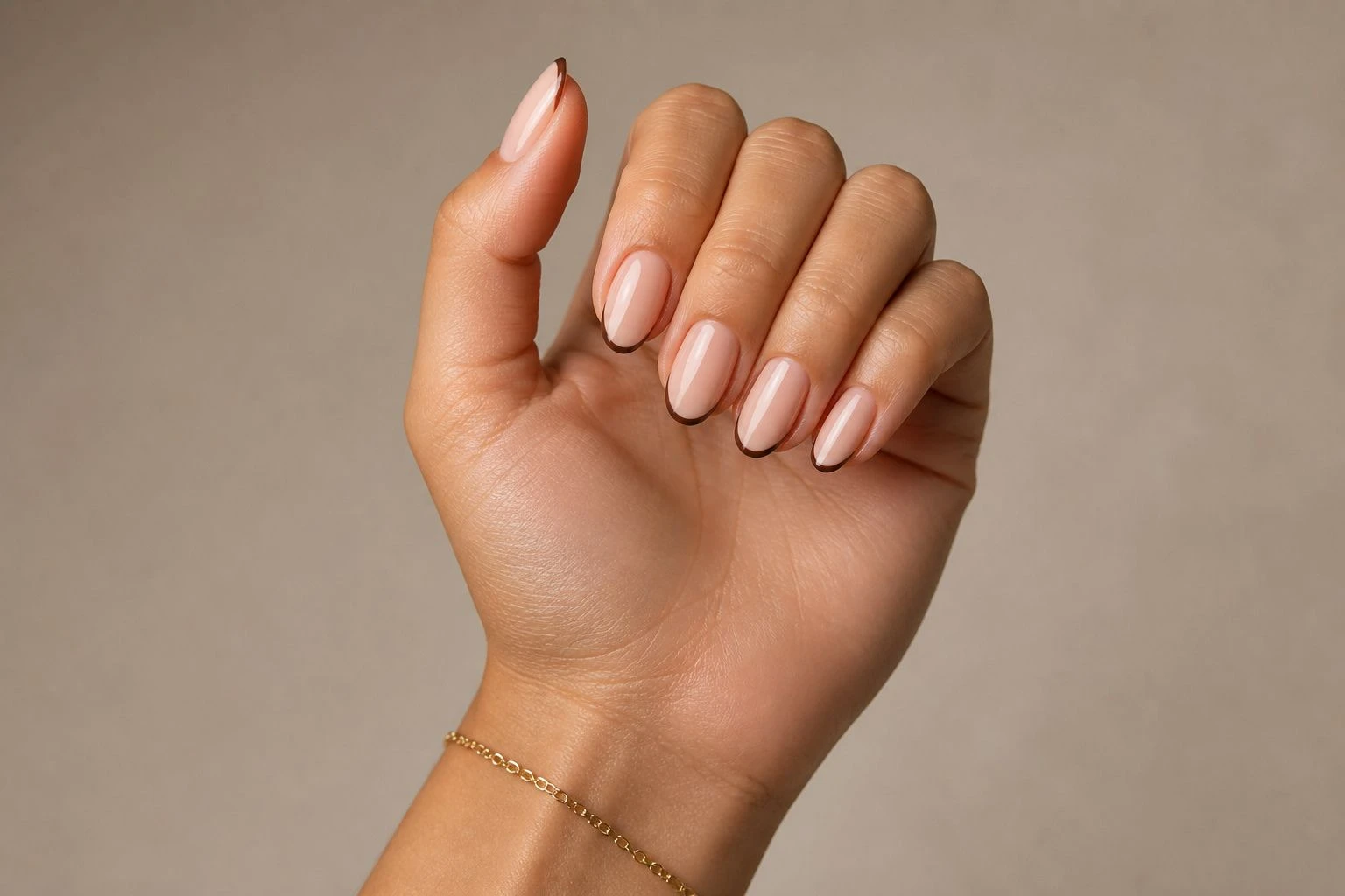 Short nude nails with cocoa brown micro French tips and a gold bracelet, Christmas nail idea