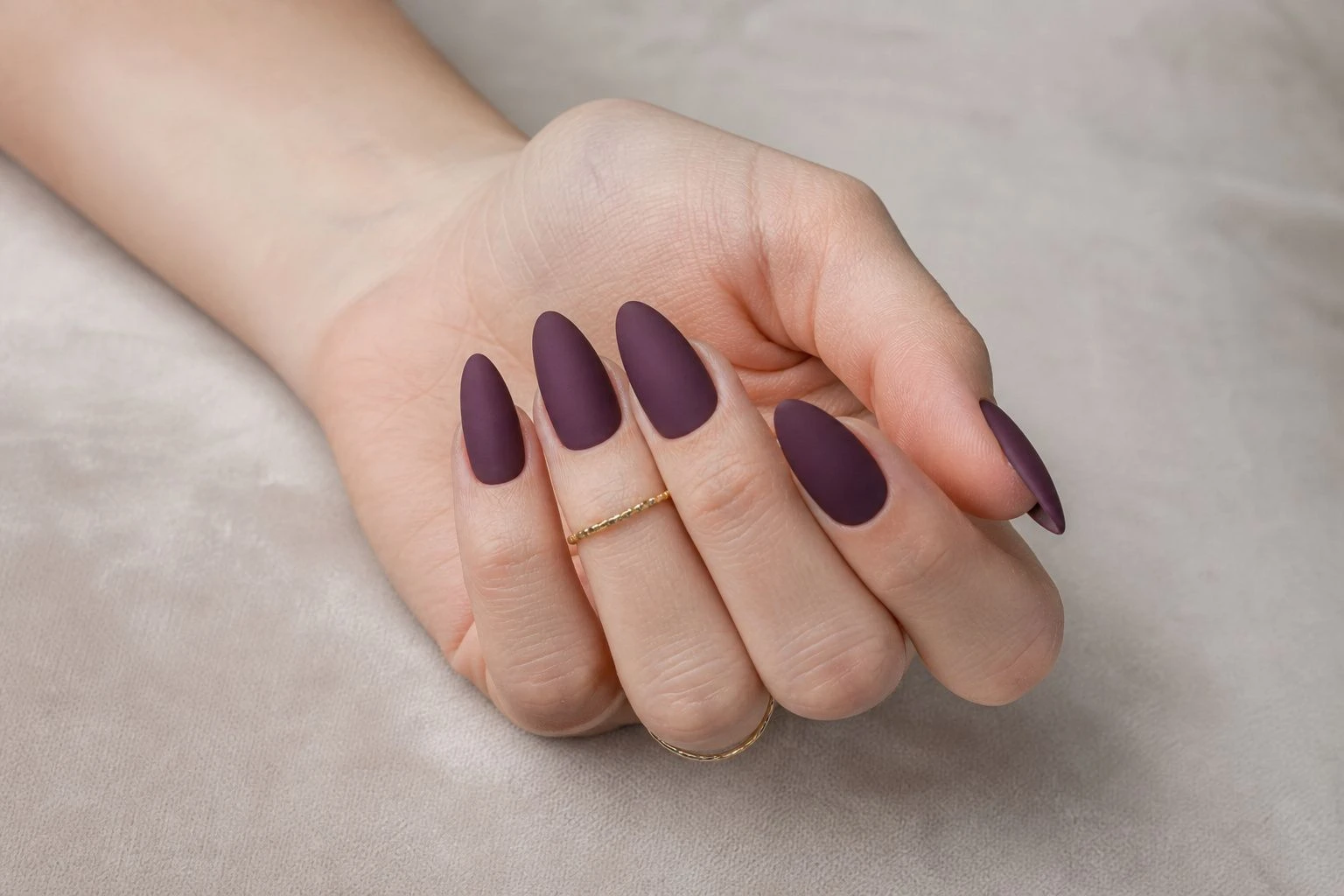 Long almond shaped plum matte velvet nails with two delicate gold rings, Christmas nail idea