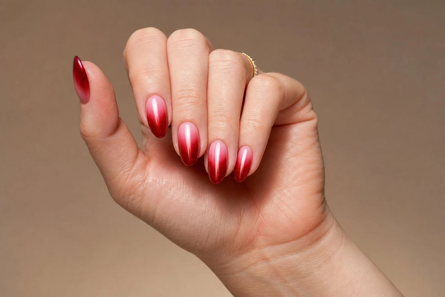 Ruby chrome ombre nails, red to pink glossy chrome fade manicure with a gold ring, Christmas nail idea