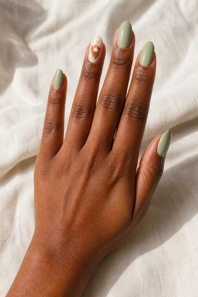 Sage and pumpkin pie inspired manicure on short square nails with glossy finish, relaxed hand pose, light olive skin tone