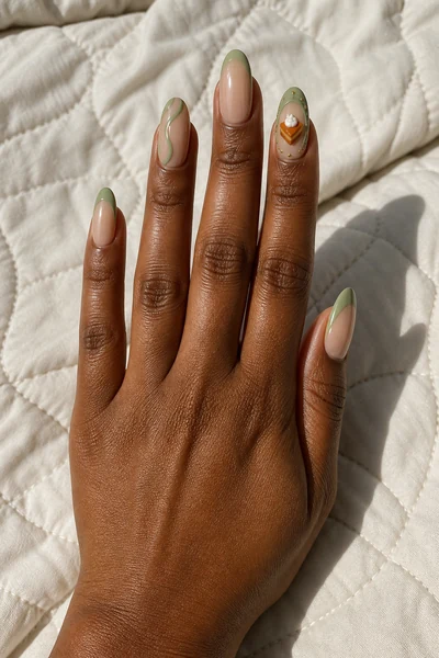 Sage framed pumpkin pie accent on medium almond nails with glossy finish, lifted hand pose, deep brown skin tone