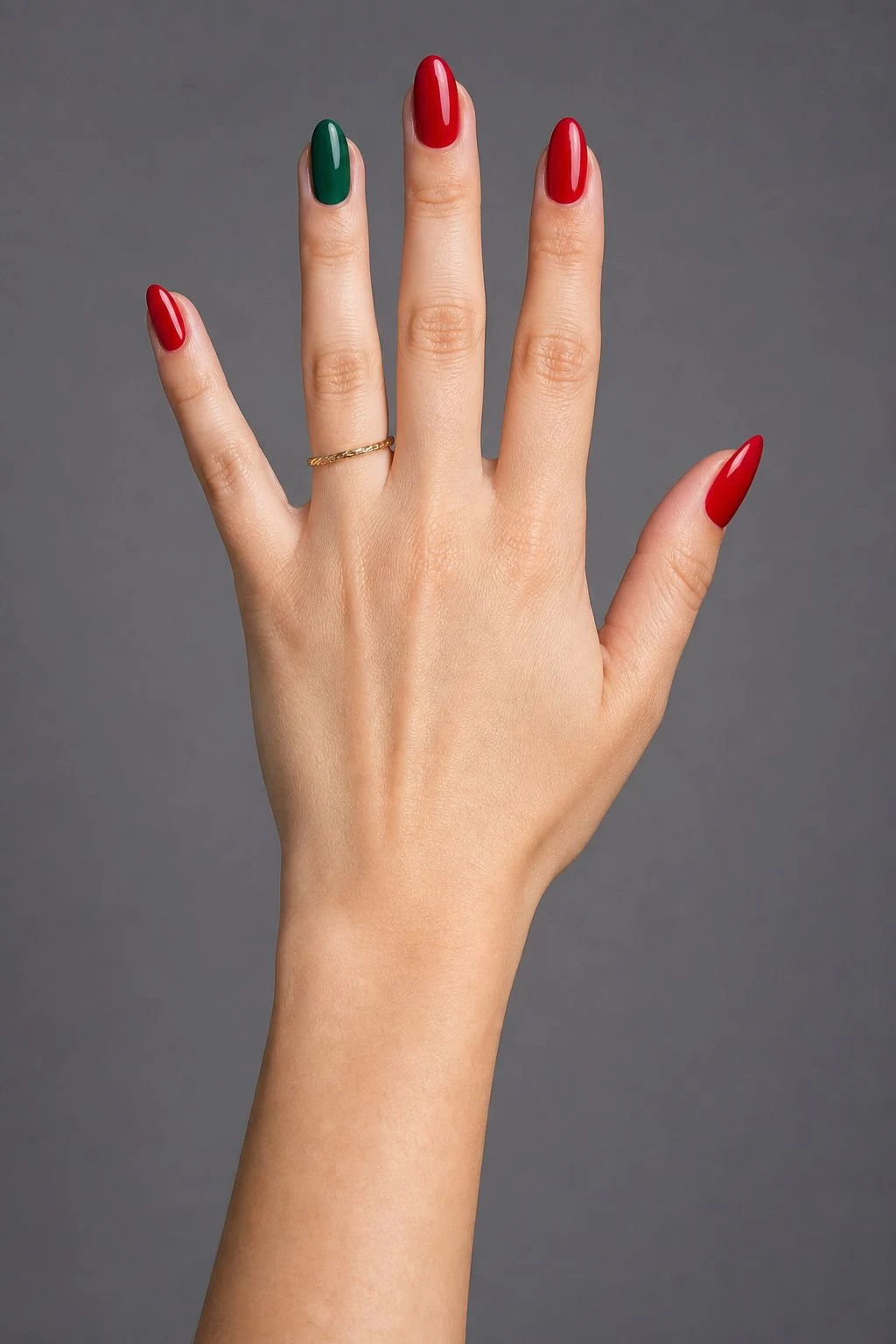 Red With Emerald Accent Christmas nails with a delicate gold ring