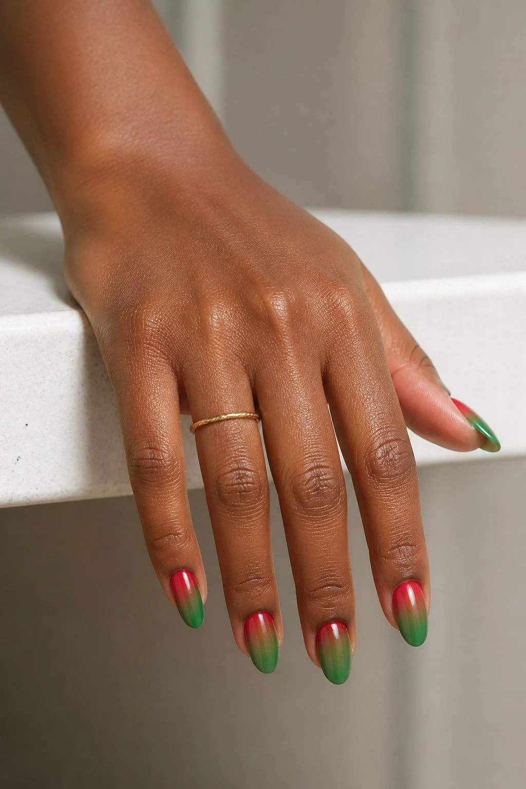 Red and Green Ombre Christmas nails with a delicate gold ring