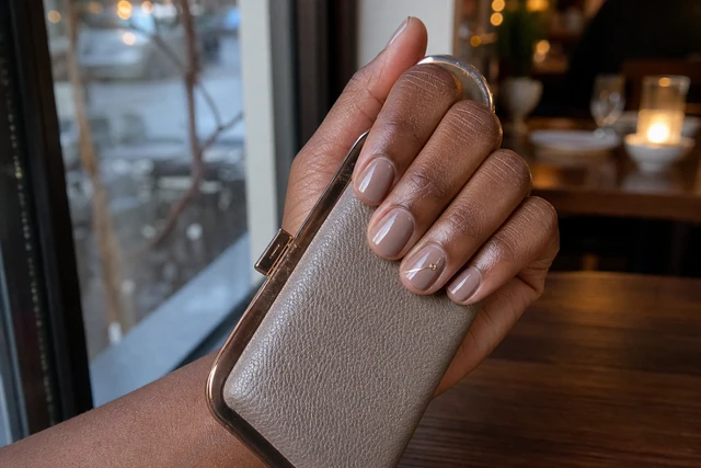 Warm taupe nude nails with a tiny gold detail